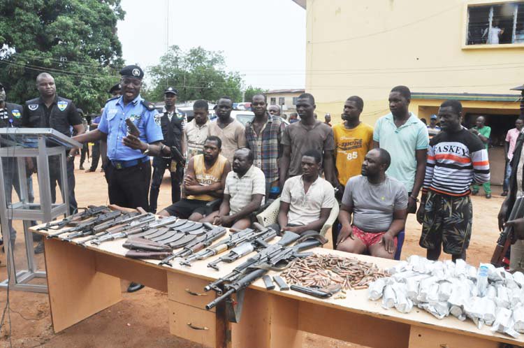 Suspects and recovered arms on parade