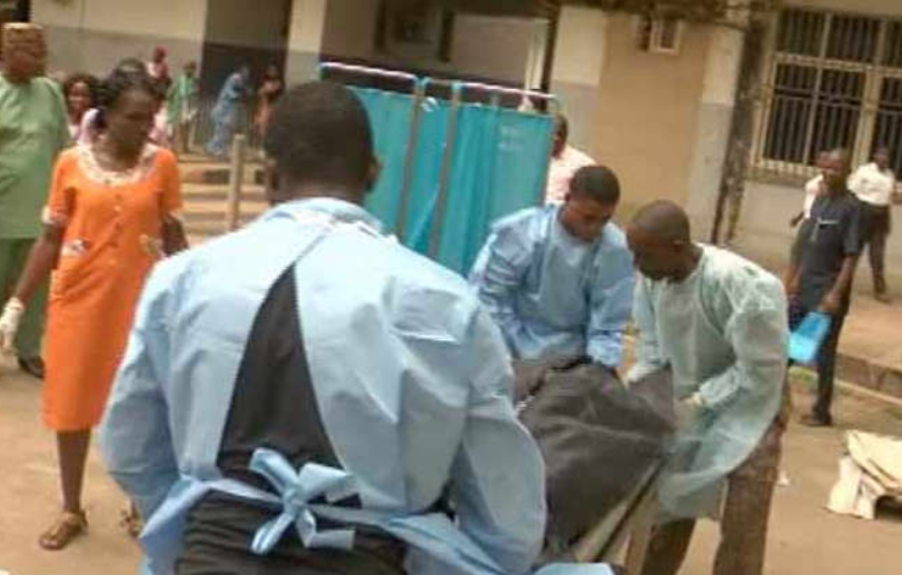 Remains of patient being evacuated by health workers...