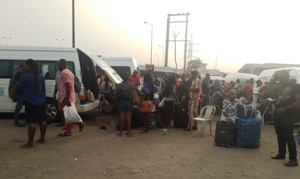 Travellers with travel tickets waiting for vehicles at a transport terminal in Lagos on Saturday