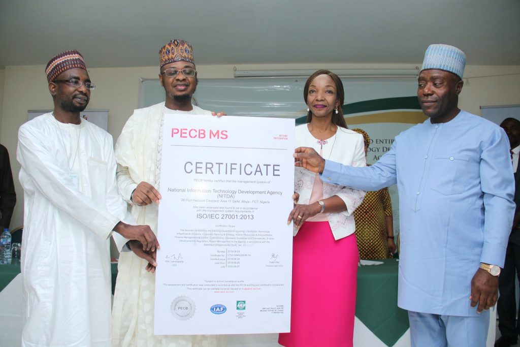 Presentation of ISO 27001: 2013 Certificate by Minister of Communications to DG, NITDA