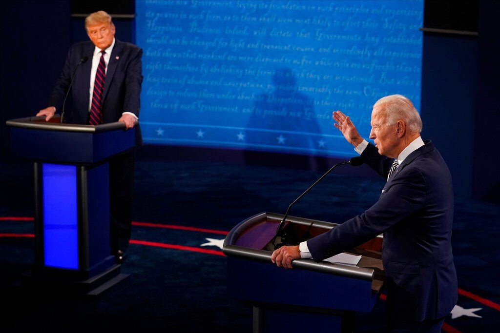 President Donald Trump listens to Democratic presidential candidate former Vice President Joe Biden during the first presidential debate Tuesday, Sept. 29, 2020, at Case Western University and Cleveland Clinic, in Cleveland, Ohio. (AP Photo/Morry Gash, Pool)