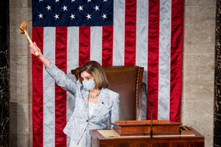 Speaker of the House Nancy Pelosi, D-CA., holds the gavel in the air on the opening day of the 117th Congress on the opening day of the 117th Congress at the U.S. Capitol in Washington, DC, U.S., January 3, 2021. Bill Clark/Pool via REUTERS