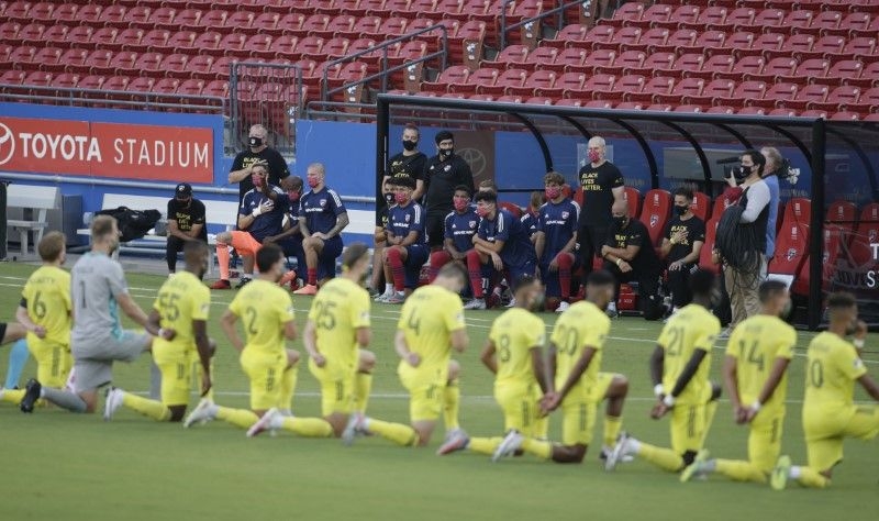 FC Dallas players and Nashville SC players kneel during the national anthem before the match at Toyota Stadium.  Tim Heitman-USA | TODAY Sports