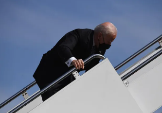 U.S. President Joe Biden stumbles as he boards Air Force One