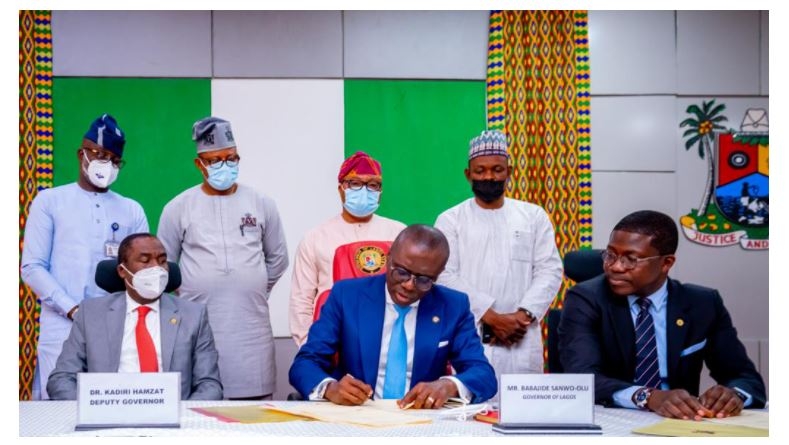 Lagos State Governor, Mr Babajide Sanwo-Olu signing bills into Law, flanked by his Deputy, Dr Obafemi Hamzat (left) and Head of Service, Mr Hakeem Muri-Okunola (right) at the Lagos House, Alausa, Ikeja, on Monday, March 15, 2021. Behind are (L-R): Chairmen, Lagos State House of Assembly Committees: Rauf Age-Sulaiman (Procurement); Victor Akande (Judiciary); Nurudeen Solaja-Saka (Public Account) and Hakeem Sokunle (Health).