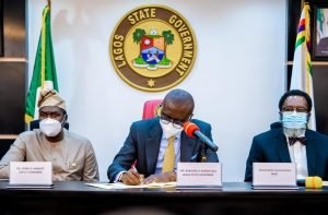 Lagos State Governor, Mr Babajide Sanwo-Olu signing bills into Law: the Lagos State Lotteries & Gaming Authority and the Public Complaints & Anti-Corruption Commission, flanked by the Deputy Governor, Dr. Obafemi Hamzat (left) and Attorney General/Commissioner for Justice, Mr Moyo Onigbanjo, SAN (right), at the Conference Room, Lagos House, Ikeja, on Monday, April 19, 2021.