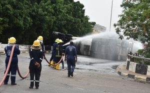 Firemen spraying water to avert fire at the scene of a tanker loaded with cooking gas that fell on Constitution Avenue at Centre Business District in Abuja on Wednesday