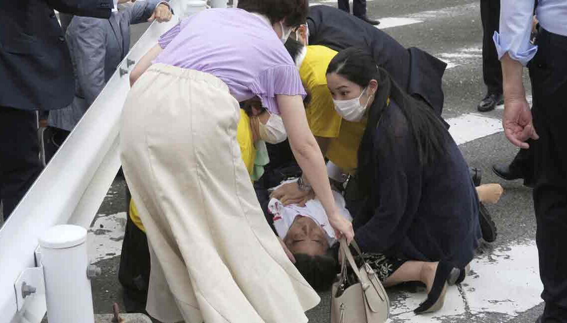 Former Japanese prime minister Shinzo Abe lies on the ground after apparent shooting during an election campaign for the July 10, 2022 Upper House election, in Nara, western Japan July 8, 2022. in this photo taken by Kyodo. Mandatory credit Kyodo via REUTERS